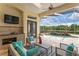 Relaxing outdoor patio with comfortable seating and views of the enclosed pool and spa waterfall feature at 17921 Arbor Haven Dr, Tampa, FL 33647