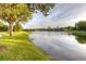 Picturesque lakeside view with walking path and lush green landscaping at 17921 Arbor Haven Dr, Tampa, FL 33647