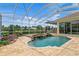 Enclosed pool features a spa with rock waterfall, and well manicured landscaping overlooking a tranquil waterfront view at 17921 Arbor Haven Dr, Tampa, FL 33647