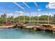 A close up of the enclosed pool featuring a rock waterfall that feeds into the clear water, and bright landscaping at 17921 Arbor Haven Dr, Tampa, FL 33647