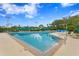 Large lap pool featuring clear blue water, poolside seating, and well-maintained deck at 17921 Arbor Haven Dr, Tampa, FL 33647