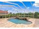 Gorgeous pool with waterfall feature under screened enclosure with scenic view at 17921 Arbor Haven Dr, Tampa, FL 33647
