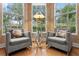 Cozy sitting area with plush armchairs and large windows offering serene views of the surrounding landscape at 17921 Arbor Haven Dr, Tampa, FL 33647