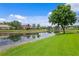 Scenic water view with lush green landscape and the reflection of the blue sky with some clouds at 17921 Arbor Haven Dr, Tampa, FL 33647