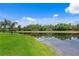 Beautiful water view with lush green landscape and the reflection of the blue sky with some clouds at 17921 Arbor Haven Dr, Tampa, FL 33647