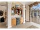 Stylish wet bar with custom cabinetry and wine cooler, perfect for entertaining and conveniently located near the outdoor living area at 17921 Arbor Haven Dr, Tampa, FL 33647