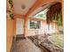 Inviting peach home exterior with white trim, a tiled walkway, and charming front yard landscaping at 1808 Elmwood Dr, Oldsmar, FL 34677