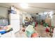 Spacious garage area with a wide roll up garage door and containing various items and storage at 1808 Elmwood Dr, Oldsmar, FL 34677