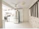 Well-lit kitchen featuring white cabinets, stainless steel fridge, and a bright tile floor at 1808 Elmwood Dr, Oldsmar, FL 34677