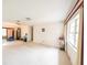 Bright living room with large windows, plush carpeting, ceiling fan, and classic chandelier at 1808 Elmwood Dr, Oldsmar, FL 34677