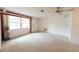 Bright living room featuring neutral carpet, large window, and a classic ceiling fan at 1808 Elmwood Dr, Oldsmar, FL 34677