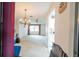 View of living room with chandelier, ceiling fan, white carpet and direct access to the kitchen at 1808 Elmwood Dr, Oldsmar, FL 34677