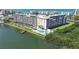 An aerial view of a waterfront condo complex with a pool and boat docks and access to the bay at 19451 Gulf Blvd # 205, Indian Shores, FL 33785