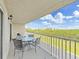 Enjoy the beautiful greenery and views from this spacious balcony with an outdoor dining set at 19451 Gulf Blvd # 205, Indian Shores, FL 33785