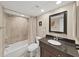 Cozy bathroom featuring a shower/tub combination and a dark vanity with sink at 19451 Gulf Blvd # 205, Indian Shores, FL 33785