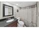 Traditional bathroom featuring a dark vanity and a shower with curtain at 19451 Gulf Blvd # 205, Indian Shores, FL 33785