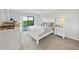 Bright primary bedroom featuring a balcony, ceiling fan and white furniture at 19451 Gulf Blvd # 205, Indian Shores, FL 33785