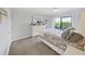 Bedroom with carpet, a balcony and a white dresser at 19451 Gulf Blvd # 205, Indian Shores, FL 33785