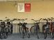 Photograph of bike racks with posted signage about bike registration and removal policies for residents at 19451 Gulf Blvd # 205, Indian Shores, FL 33785