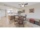 Dining room with decorative chairs and views into the kitchen and living spaces at 19451 Gulf Blvd # 205, Indian Shores, FL 33785