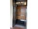 The elevator has stainless steel doors and wood paneled walls at 19451 Gulf Blvd # 205, Indian Shores, FL 33785