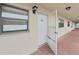 Unit 205 entrance, showing front door with screen door and window at 19451 Gulf Blvd # 205, Indian Shores, FL 33785