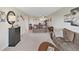 Bright living room with carpet, comfortable seating, and view of kitchen area at 19451 Gulf Blvd # 205, Indian Shores, FL 33785