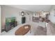 Spacious living area featuring carpet, a brown sofa, and TV with exterior view at 19451 Gulf Blvd # 205, Indian Shores, FL 33785