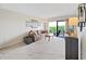 Cozy living room with comfortable sofa, balcony access, and natural light at 19451 Gulf Blvd # 205, Indian Shores, FL 33785