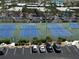 Overhead shot of community tennis courts and parking, showcasing the complex's recreational amenities at 19451 Gulf Blvd # 205, Indian Shores, FL 33785
