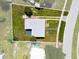 Aerial view of the property, showing the roof, driveway, and surrounding yard with partial property outline at 21536 Holdern Ave, Port Charlotte, FL 33952