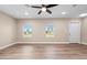 Spacious bedroom with hardwood floors, neutral walls, and bright windows at 21536 Holdern Ave, Port Charlotte, FL 33952