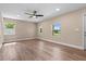 Bright living room featuring wood floors, neutral paint, ceiling fan, and multiple windows at 21536 Holdern Ave, Port Charlotte, FL 33952