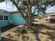 Backyard with a combination of gravel, green, and dead grass, showcasing ample space and potential at 2175 20Th Sw Ave, Largo, FL 33774