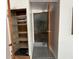 View of the basement with open closet with shelving and partially opened entrance at 2175 20Th Sw Ave, Largo, FL 33774