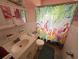 Bathroom showcasing a vanity, toilet, and colorful flamingo-themed shower curtain at 2175 20Th Sw Ave, Largo, FL 33774