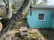 Exterior view of house featuring blue walls and mature tree at 2175 20Th Sw Ave, Largo, FL 33774
