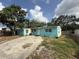 Charming single-story home featuring a light blue exterior, white trim, and a concrete driveway at 2175 20Th Sw Ave, Largo, FL 33774