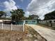 Charming single-story home featuring a light blue exterior, white trim, and a concrete driveway at 2175 20Th Sw Ave, Largo, FL 33774