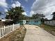 Charming single-story home featuring a light blue exterior, white trim, and a concrete driveway at 2175 20Th Sw Ave, Largo, FL 33774