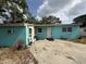 Exterior of home features a blue exterior, front entrance, and concrete slab at 2175 20Th Sw Ave, Largo, FL 33774