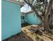 Image displaying the light blue exterior with neat trim and a view into the backyard at 2175 20Th Sw Ave, Largo, FL 33774