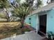 Exterior of home featuring blue walls and open door at 2175 20Th Sw Ave, Largo, FL 33774