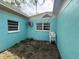 Shows the exterior of the house with air conditioning unit and blue walls at 2175 20Th Sw Ave, Largo, FL 33774