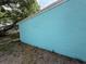 Close-up on the turquoise stucco exterior of the home, showcasing a clean and modern aesthetic at 2175 20Th Sw Ave, Largo, FL 33774