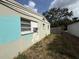 Shows the side of the house with an air conditioning unit and fenced yard at 2175 20Th Sw Ave, Largo, FL 33774