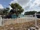 View of the front yard with a white picket fence and a Century 21 real estate sign at 2175 20Th Sw Ave, Largo, FL 33774