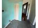 Laundry room featuring bi-fold closet doors, teal walls, and a gray painted floor at 2175 20Th Sw Ave, Largo, FL 33774