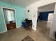 Cozy living room with terrazzo flooring and neutral walls, leading to the dining area at 2175 20Th Sw Ave, Largo, FL 33774