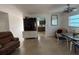 Bright living area with terrazzo flooring, neutral paint, and kitchen view at 2175 20Th Sw Ave, Largo, FL 33774